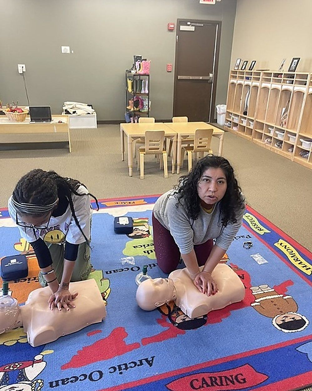 Pam Goldsberry, RN, demonstrating chest compressions while a class watches