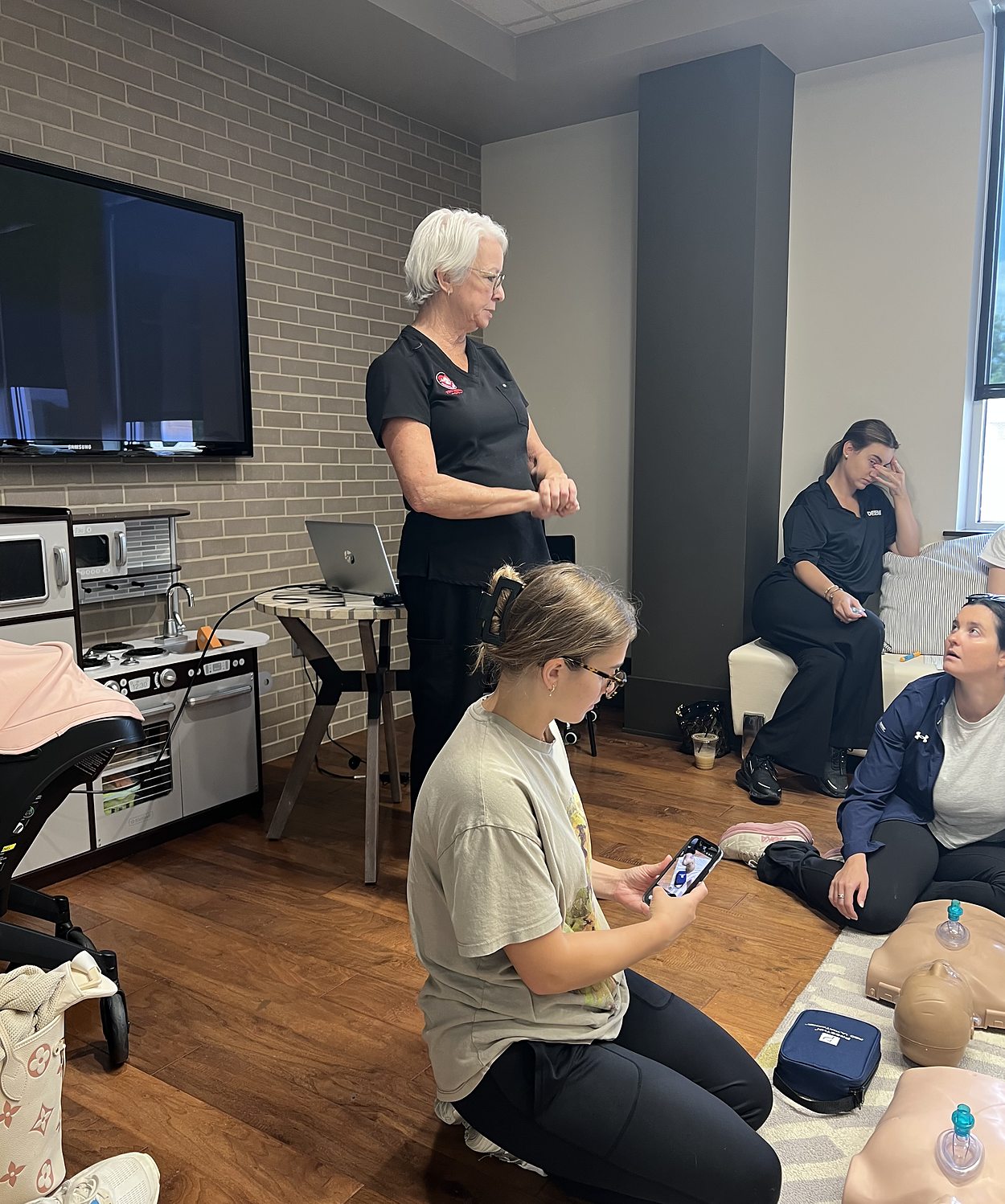 Pam Goldsberry, RN, talking a group through the sequence during an on site CPR class