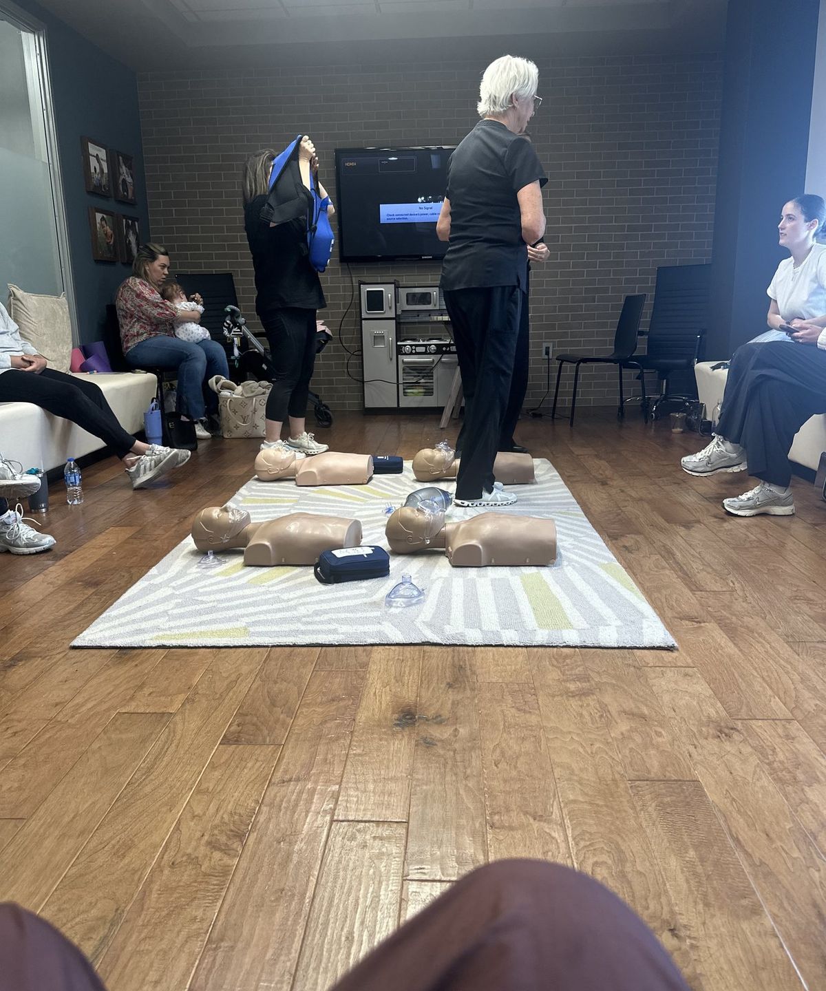 Pam Goldsberry, RN, demonstrating chest compressions while a class watches