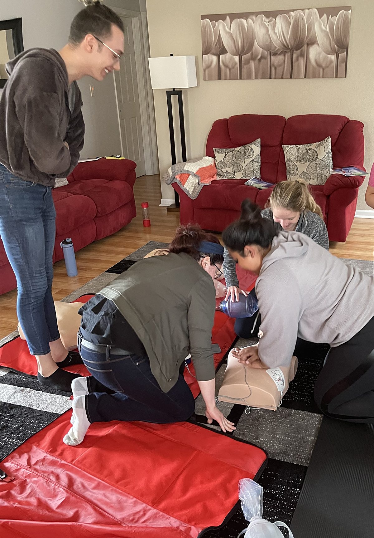 Guests practicing chest compressions during an in home CPR class